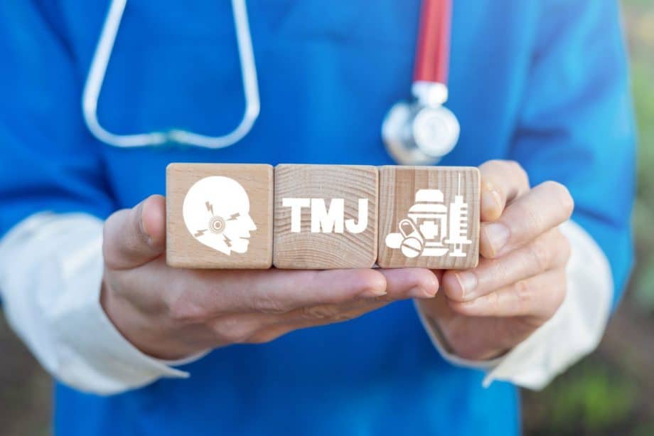 person hold three wood blocks representing TMJ disorder