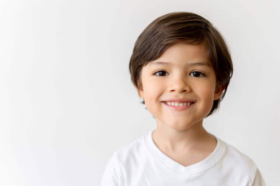 smiling toddler boy in white t-shirt