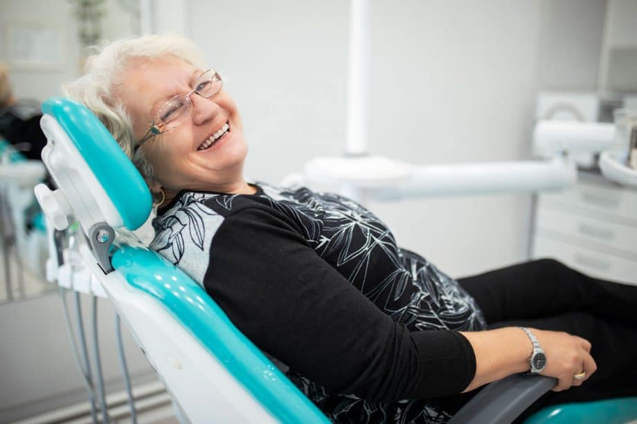 senior woman in dental chair, smiling