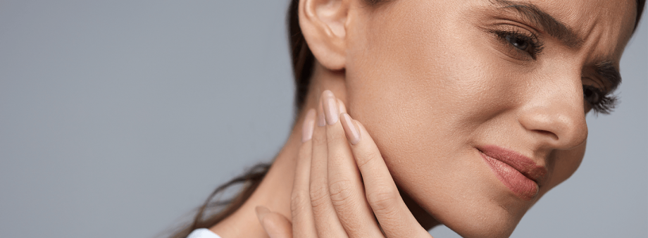 side profile of woman touching her jaw in pain